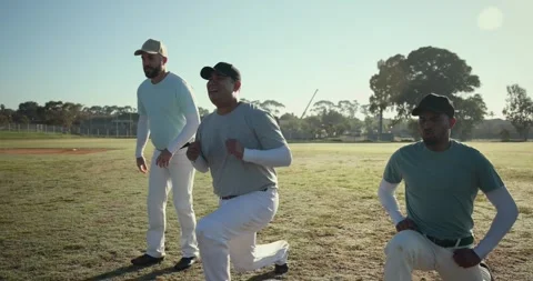 Sun prompting three male baseball players warming up in outfield jogging lunging Stock Footage 342111471