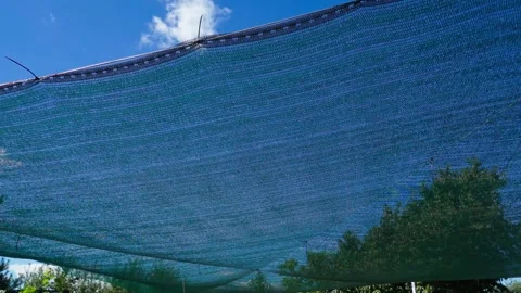 Sun-protective shade net for UV protection on hot summer days Stock Footage 284928008