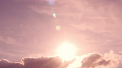 Sun on Puffy Cloud and Cirrus Light Clouds with Cumulus Cloud at Dawn Coral Pink Stock-Footage 196277345