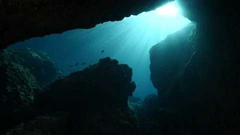Sun ray beams underwater cave light scenery scuba divers to see  backgrounds Stock Footage 167369211