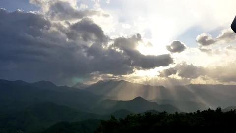 Sun ray breaking through cloud from the top of mountain moiwa, hokkaido, japan Stock Footage 81226259