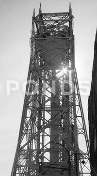 Sun ray through metal suspension bridge Stock Photos