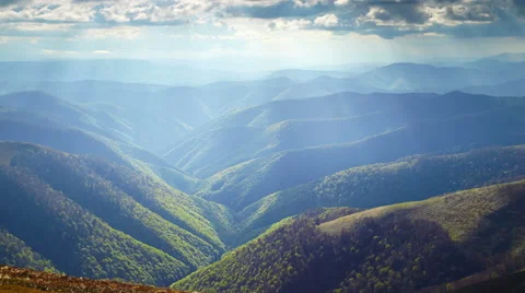 Sun rays above the slopes of mountains Stock Footage 67550531