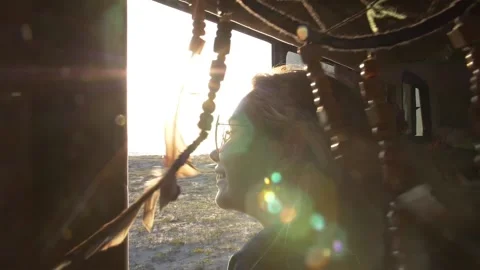 Sun rays and glare against the background of a dream catcher swinging in the Stock Footage 111651862