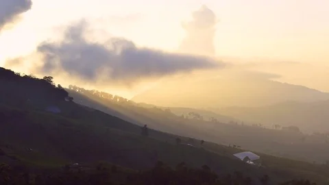 Sun rays are shining from behind a cloud with the mountain. FullHD 1080p. Stock Footage 76381930