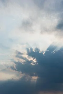 Sun rays are striking through the clouds Stock Photos