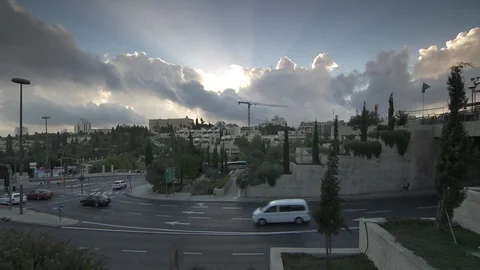 Sun rays beam behind clouds over Jerusalem Stock Footage 86759183