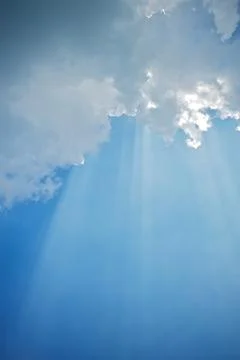 Sun rays beaming through the clouds Stock Photos