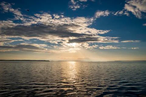 Sun rays beaming through picturesque clouds Stock Photos