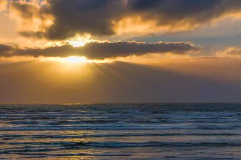 Sun rays behind approaching storm over Pacific Ocean off Olympic Peninsula.  Stock Photos