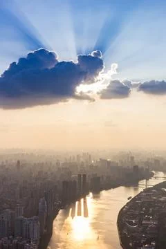 Sun rays behind a cloud over the Pearl River at sunset in Guangzhou Photos