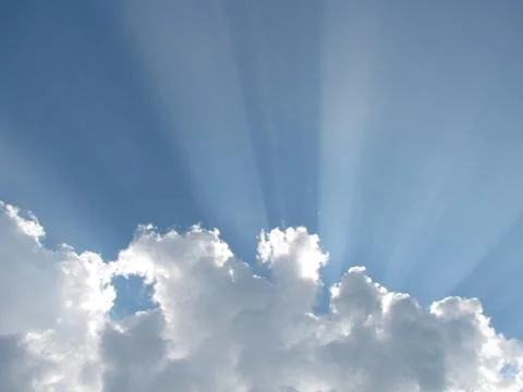 Sun rays behind cloud Stock Photos