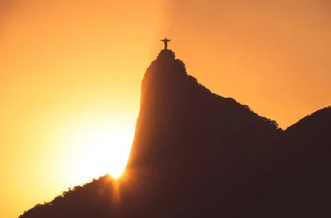 Sun rays behind the Corcovado mountain with Christ the Redeemer Photos