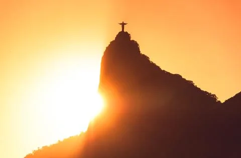 Sun rays behind the Corcovado mountain with Christ the Redeemer 스톡 사진