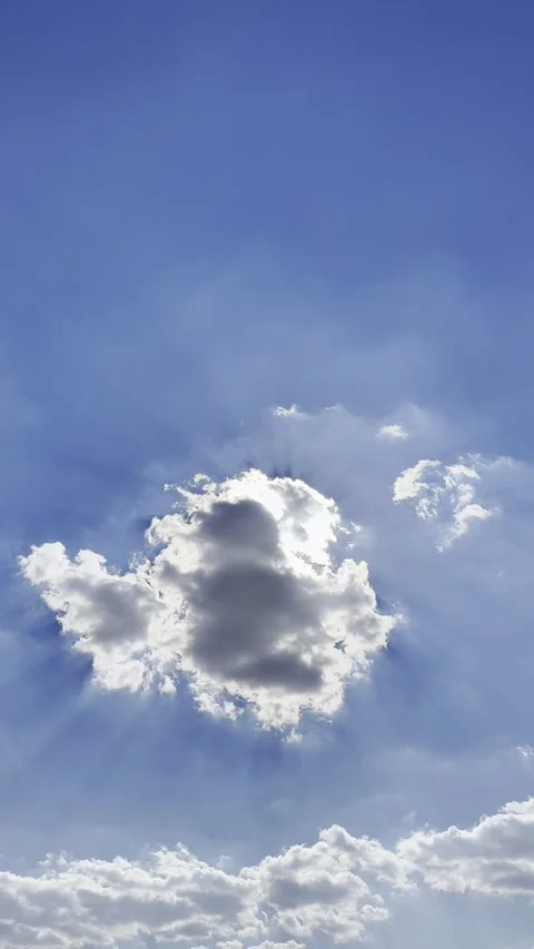 Sun Rays Behind Dark Cloud in Blue Sky Stock Footage 345923041
