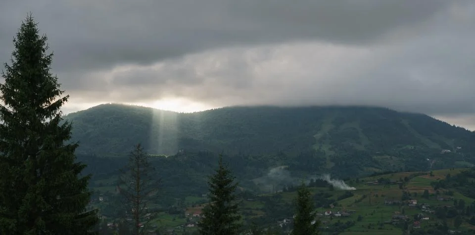 Sun rays between clouds on carpathian mountains in Ukraine Foto stock