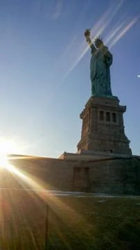 Sun rays blessing the Liberty statue in USA Stock Photos