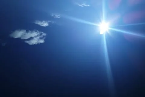 Sun rays in the blue sky background Stock Photos