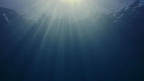 Sun rays in blue water, waves on the water surface, abstract Stock Footage 143547887