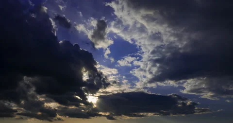 Sun rays break through dark storm clouds Stock Footage 194100175