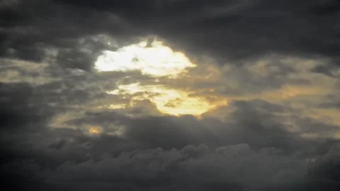 Sun rays break through a hole in cloudy sky during timelapse - Overcast Heavens Stock Footage 339646434