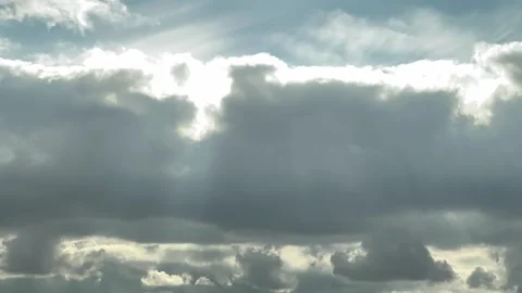 Sun rays breaking through afternoon clouds in warm timelapse Stock Footage 343070186