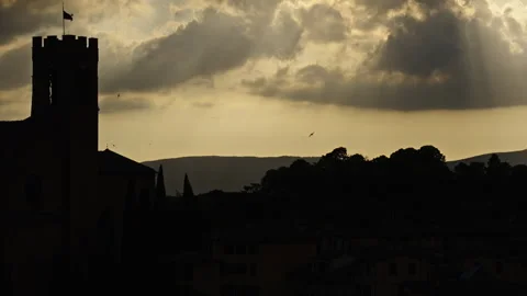 Sun Rays Breaking Through Clouds Over Tower Silhouette Stock Footage 256163270