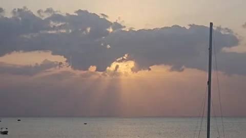 Sun Rays Breaking Through Clouds Over Sea With Mast, Nungwi, Zanzibar, Tanzania Video stock 313906721