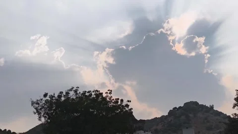 Sun Rays Breaking Through Clouds Over Hills Stock Footage 327970068