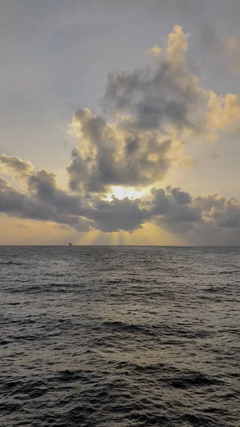 Sun Rays Breaking Through Clouds Over Open Ocean Stock Footage 336514899