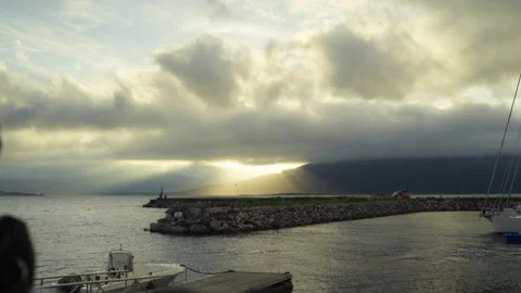 Sun Rays Breaking Through Clouds Over Norwegian Harbor Breakwater Stockbeeldmateriaal 337425230