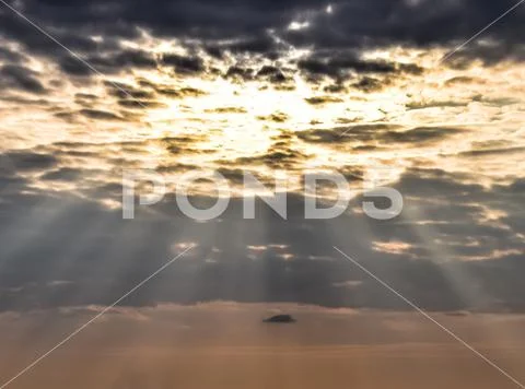 Sun rays breaking through cumulus clouds. Heavenly landscape Stock Photos