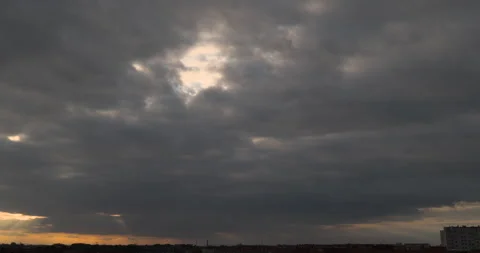 Sun rays breaking through dark clouds during sunset. Timelapse. Stock Footage 252948737