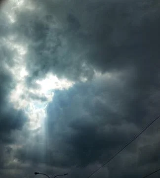Sun Rays Breaking Through Dark Clouds Dramatic Sky Background Stock Photos