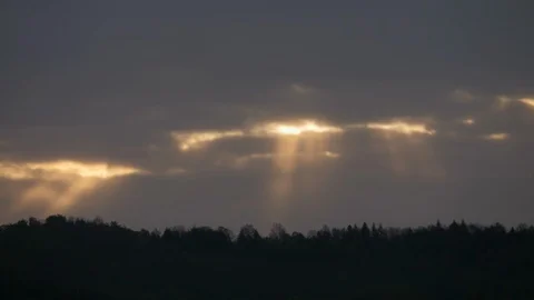 Sun rays breaking through dense cloud cover creating an impression of heaven Stock Footage 107650184