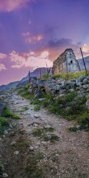Sun rays breaking through the mountain at sunset. Family crypts on the mountain Fotos de archivo