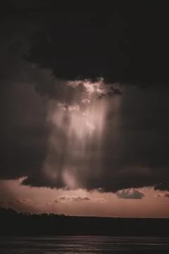 Sun Rays Breaking Through Storm Clouds on Zambezi River Stock Photos