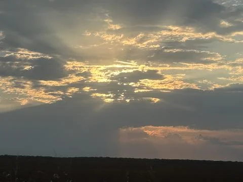Sun Rays Breaking Through Storm Clouds Over Rural Landscape Fotos Stock