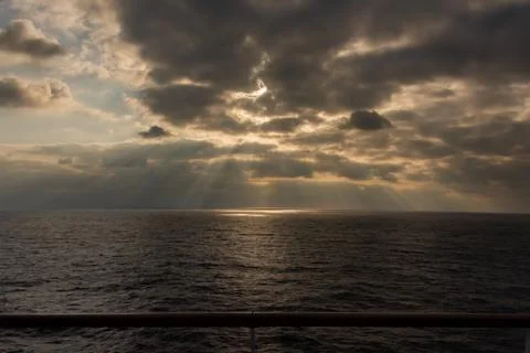 Sun rays bursting through cloud Stock Photos