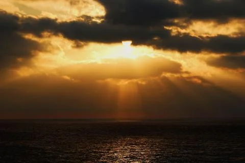 Sun rays bursting through the clouds Stock Photos