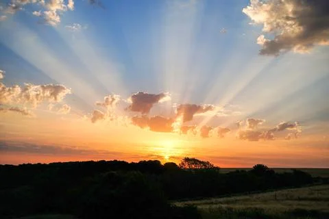 Sun rays in clouds in the sunrise and sunset 写真素材
