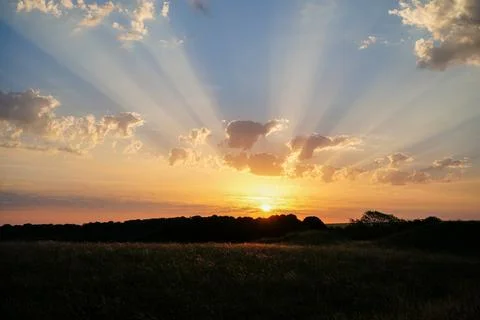 Sun rays in clouds in the sunrise and sunset 写真素材