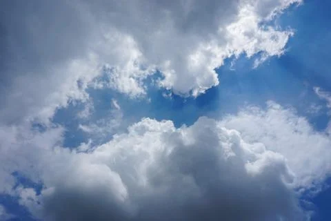 SUN RAYS COMING OUT OF THE CLOUDS Stock Photos