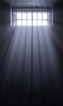 Sun rays in dark prison cell Stock Photos