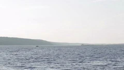 Sun rays emerging through clouds in the middle of the rough exotic Stock Footage 133138095