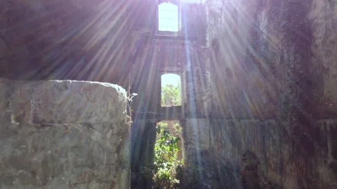 Sun rays entering abandoned hacienda through window opening with stone walls Stock Footage 334622111