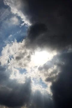 Sun rays filtering through different cloud shapes Stock Photos