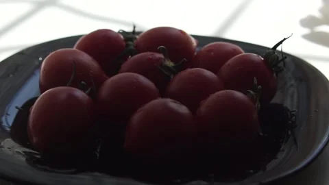 Sun rays goes over the plate with tomatoes Stock Footage 133344655