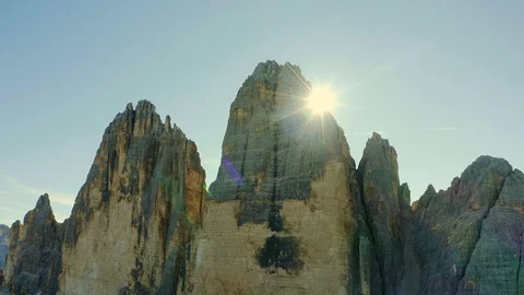 Sun Rays going back of the Three Peaks  of Lavaredo Mountains Stockbeeldmateriaal 128947690