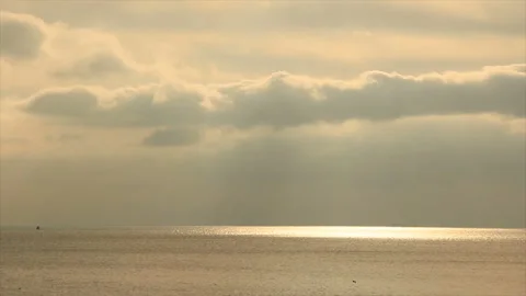 The sun rays illuminate the surface of the sea Stock Footage 155357626